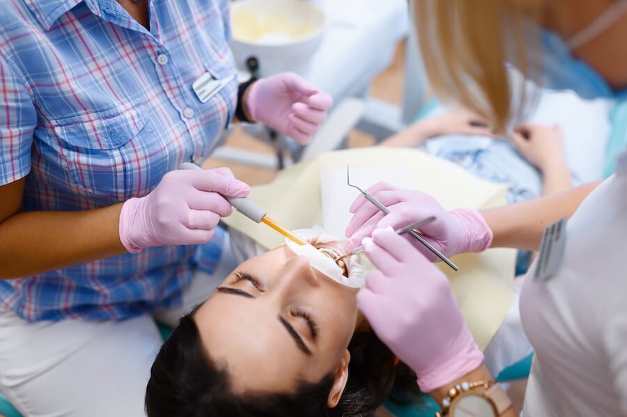 female dentist and assistant